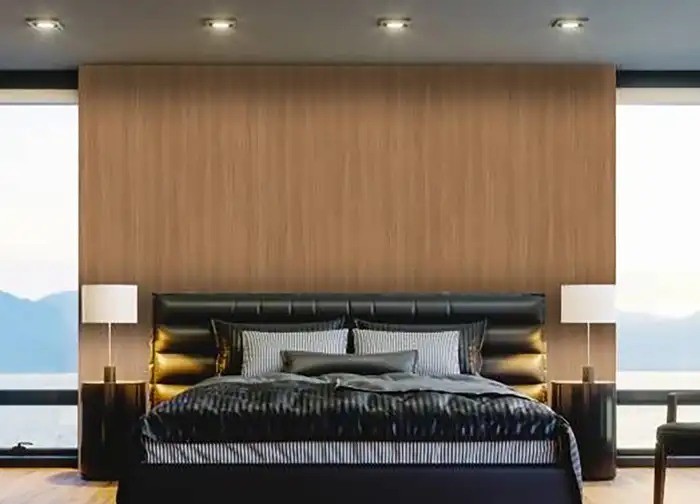 Modernes Schlafzimmer mit Holzpaneel-Wand in natürlicher Optik, gepolstertem Bett und warm beleuchteten Nachttischen – stilvolles Interior Design mit Cover Styl Möbelfolie in Holzdekor.